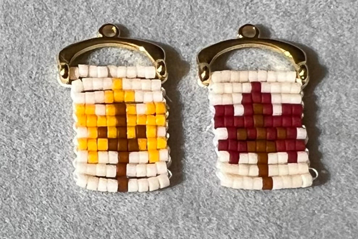 Pair of beaded earrings with geometric patterns on a gray background